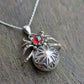 A detailed gothic rose window inspired spider made from Sterling Silver and 9ct yellow Gold featuring a blood-red garnet cabochon as the head of the spider. Each leg has a gold ball on where the leg bends and the spiders abdomen has a meticulously hand crafted gothic rose design.