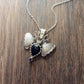 Sterling Silver Moth Pendant featuring Rose cut dark blue sapphire and iolite. Detailed moth wings are made up of two months meeting at top where deer antlers are in place of antennas.