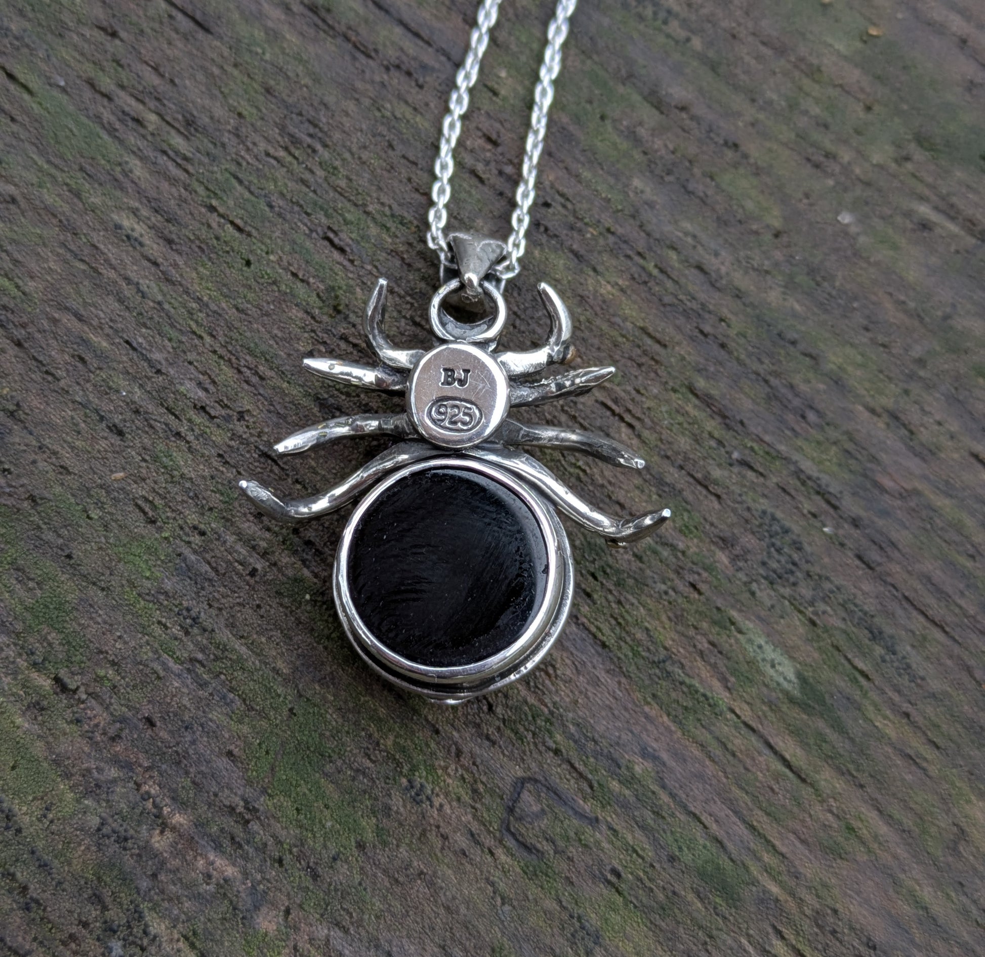Beneath this gothic rose window inspired spider pendant made from Sterling Silver and 9ct yellow Gold there is a hidden gem- a beautiful black onyx cabochon.