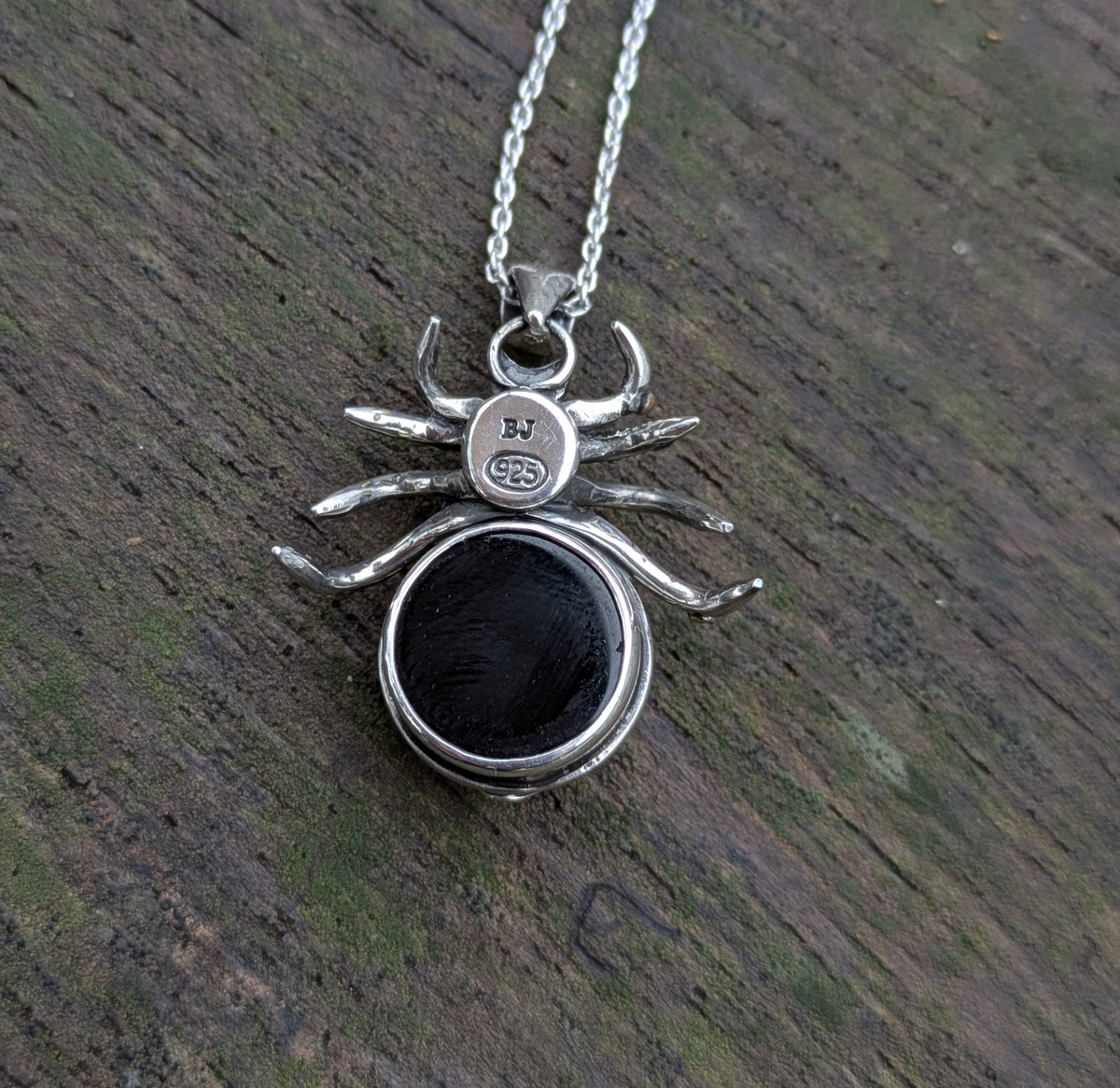 Beneath this gothic rose window inspired spider pendant made from Sterling Silver and 9ct yellow Gold there is a hidden gem- a beautiful black onyx cabochon.