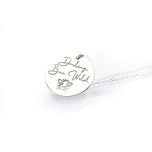 Sterling silver disc pendant stamped with motivational message; Darling, Bee Wild. Made in Australia from ethically sourced silver.