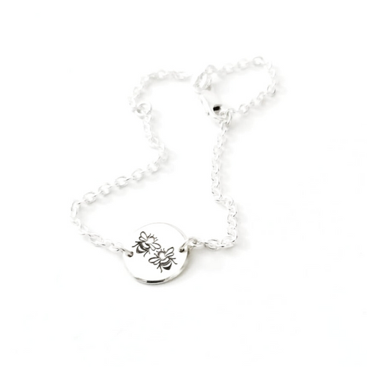 Children's sterling silver bracelet with bee design and safety chain mechanism. 